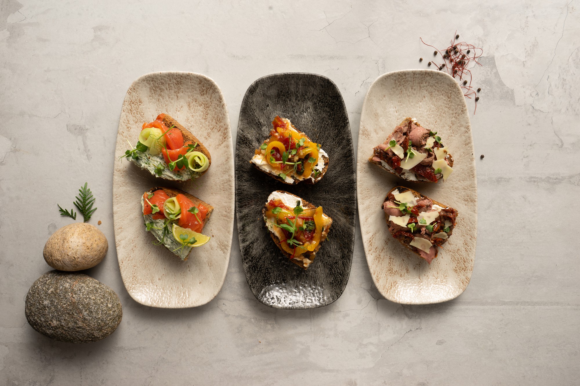 Tasting menu with multiple small plates on slate